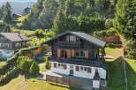 Nestled amidst lush greenery and rolling hills, this charming chalet offers a serene mountain retreat.