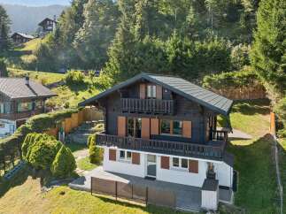 Nestled amidst lush greenery and rolling hills, this charming chalet offers a serene mountain retreat.