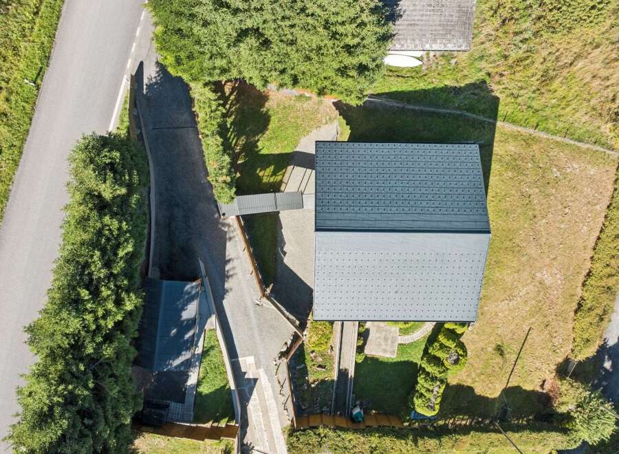 Discover this stunning property featuring a modern dark grey metal roof, perfect for durability and style.