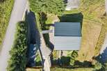 Discover this stunning property featuring a modern dark grey metal roof, perfect for durability and style.