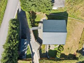 Discover this stunning property featuring a modern dark grey metal roof, perfect for durability and style.