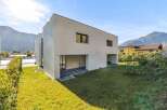 Discover modern living in this stunning contemporary home, featuring a sleek white facade and expansive green lawn.