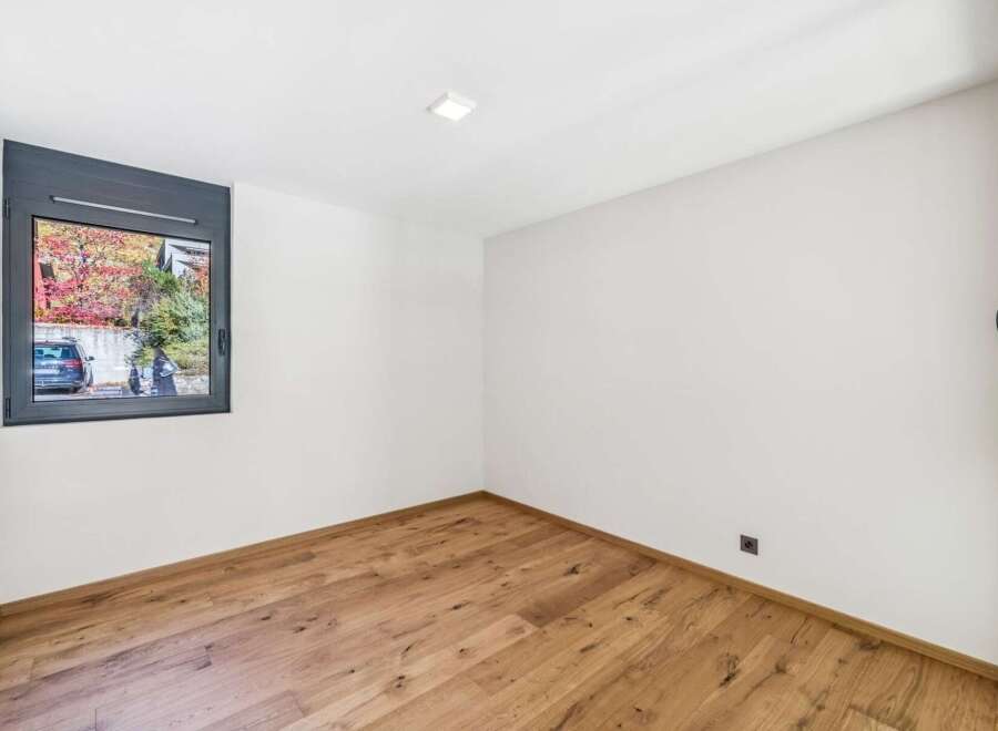 Discover this bright and airy room featuring a modern aesthetic with clean white walls and a beautiful hardwood floor.