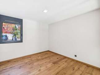 Discover this bright and airy room featuring a modern aesthetic with clean white walls and a beautiful hardwood floor.