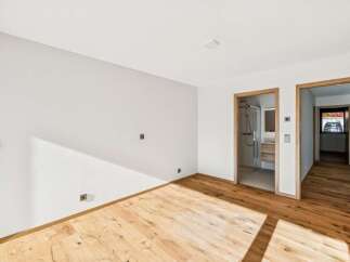 Experience modern living in this beautifully appointed room featuring a sleek en-suite bathroom with a glass-enclosed shower.