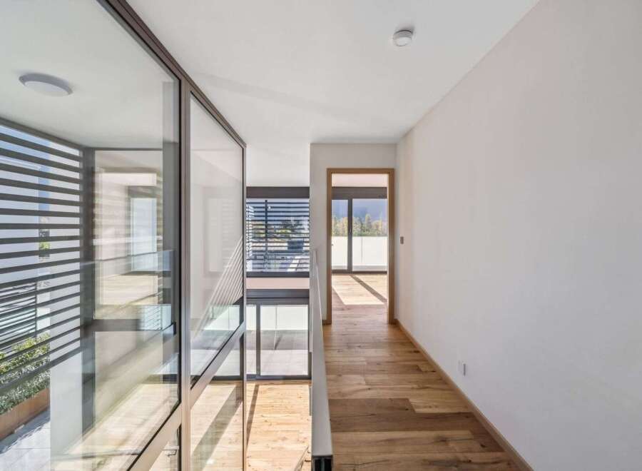Experience modern living in this stunning home featuring expansive glass walls that flood the interior with natural light.