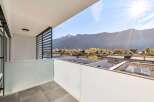 Enjoy breathtaking mountain views from this modern balcony, perfect for relaxing or entertaining.