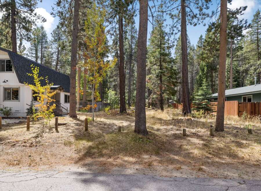 Nestled amongst tall pine trees, this charming property offers a serene mountain retreat.