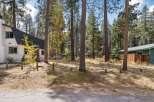 Nestled amongst tall pine trees, this charming property offers a serene mountain retreat.