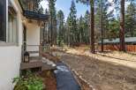 Discover this charming home nestled amongst tall pine trees, offering a serene and private setting.