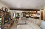 Cozy living room featuring a large stone fireplace and a comfortable sectional sofa, perfect for relaxing evenings.