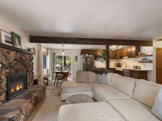 Cozy living room featuring a large stone fireplace and a comfortable sectional sofa, perfect for relaxing evenings.