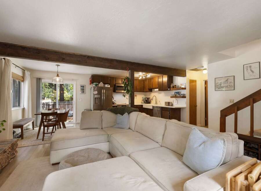 Experience cozy living in this open-concept home featuring a spacious sectional sofa perfect for gatherings.