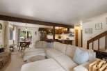 Experience cozy living in this open-concept home featuring a spacious sectional sofa perfect for gatherings.