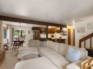 Experience cozy living in this open-concept home featuring a spacious sectional sofa perfect for gatherings.