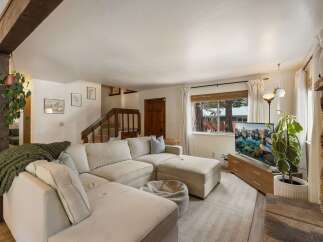 Step into this inviting living room, featuring a plush sectional sofa perfect for relaxation and a large TV for entertainment.
