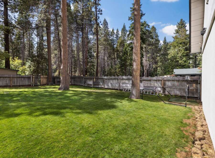 Enjoy the expansive, beautifully manicured lawn in this spacious backyard, perfect for outdoor activities and relaxation.