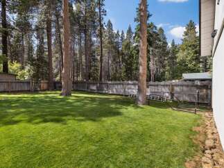 Enjoy the expansive, beautifully manicured lawn in this spacious backyard, perfect for outdoor activities and relaxation.