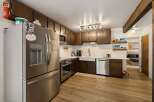 Discover this charming kitchen featuring stainless steel appliances, including a French door refrigerator and a built-in microwave.