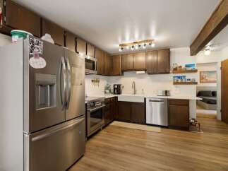 Discover this charming kitchen featuring stainless steel appliances, including a French door refrigerator and a built-in microwave.