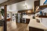 Discover this charming kitchen featuring rich wood cabinetry, a sleek stainless steel refrigerator, and a modern microwave.