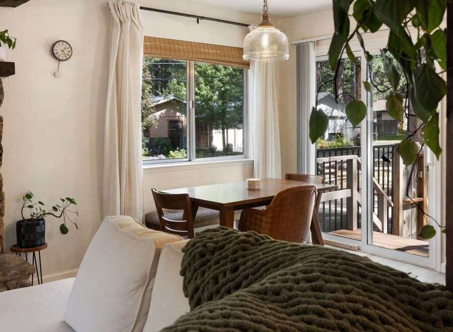 Enjoy cozy meals in this charming dining area, featuring a warm wooden table and comfortable seating.