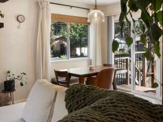 Enjoy cozy meals in this charming dining area, featuring a warm wooden table and comfortable seating.