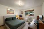 This charming bedroom offers a comfortable queen-size bed with plush bedding, perfect for restful nights.