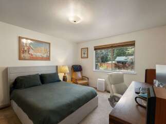 This charming bedroom offers a comfortable queen-size bed with plush bedding, perfect for restful nights.