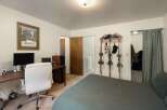This bedroom offers a dedicated workspace with a desk and office chair, perfect for remote work or study.