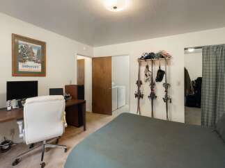 This bedroom offers a dedicated workspace with a desk and office chair, perfect for remote work or study.