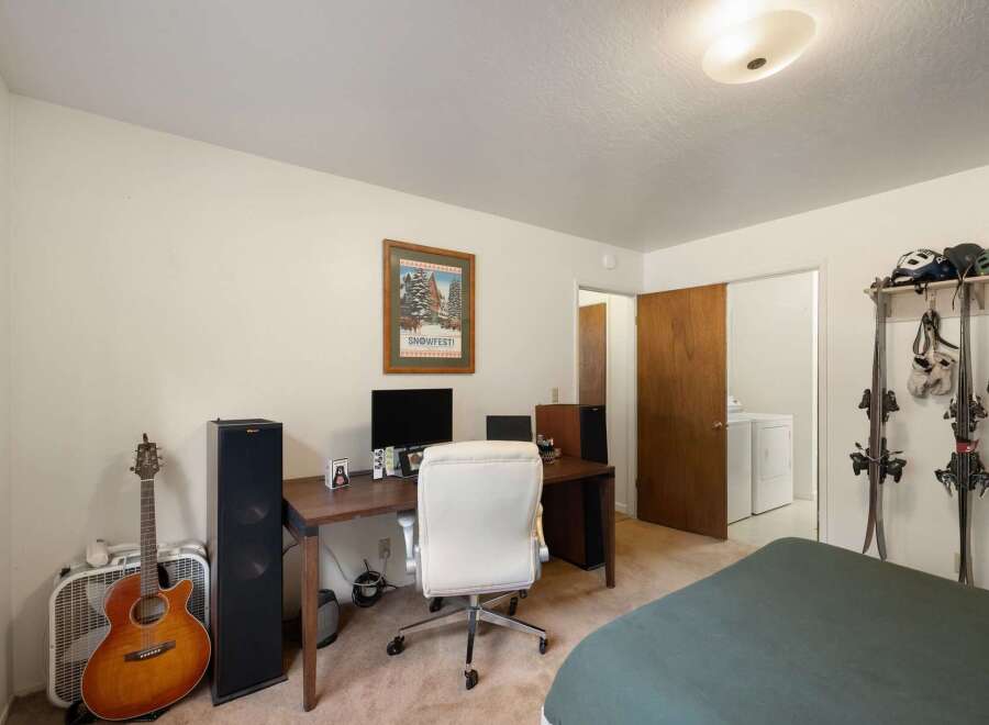 This versatile room offers a dedicated workspace with a desk, computer, and comfortable office chair, perfect for remote work or study.