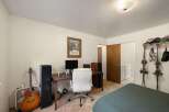This versatile room offers a dedicated workspace with a desk, computer, and comfortable office chair, perfect for remote work or study.
