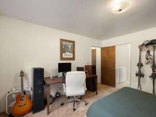 This versatile room offers a dedicated workspace with a desk, computer, and comfortable office chair, perfect for remote work or study.