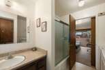 This bathroom features a spacious vanity with ample counter space and a large mirror, perfect for your morning routine.