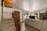 Step into this inviting living space featuring a cozy stone fireplace and a large sectional sofa perfect for gatherings.
