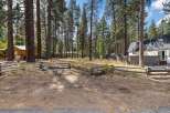 Nestled among tall pine trees, this property offers a serene and private setting.