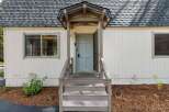 Charming home featuring a welcoming light blue front door, perfect for greeting guests.