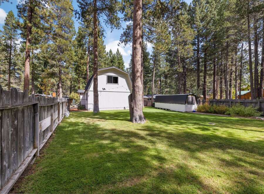 Enjoy the expansive backyard of this property, complete with a large, well-maintained lawn perfect for outdoor activities and relaxation.