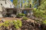 Enjoy outdoor living on this charming patio, perfect for al fresco dining or morning coffee surrounded by mature trees.