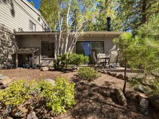Enjoy outdoor living on this charming patio, perfect for al fresco dining or morning coffee surrounded by mature trees.