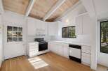 Charming kitchen featuring white cabinetry, a gas range, and a dishwasher, perfect for home chefs.