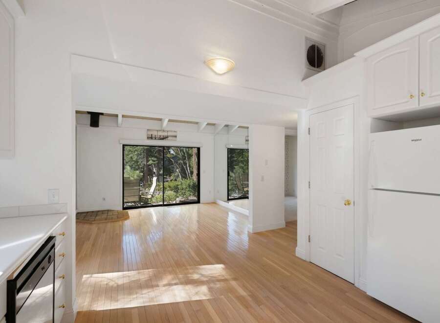 Experience bright and airy living in this charming home, featuring gleaming hardwood floors that reflect abundant natural light.