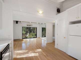 Experience bright and airy living in this charming home, featuring gleaming hardwood floors that reflect abundant natural light.