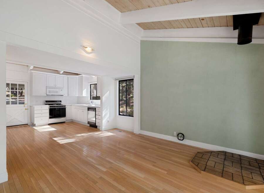 Discover this charming home featuring a bright and airy open-concept living space with gleaming hardwood floors.