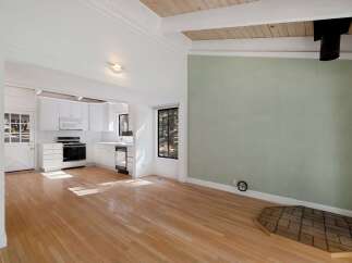 Discover this charming home featuring a bright and airy open-concept living space with gleaming hardwood floors.
