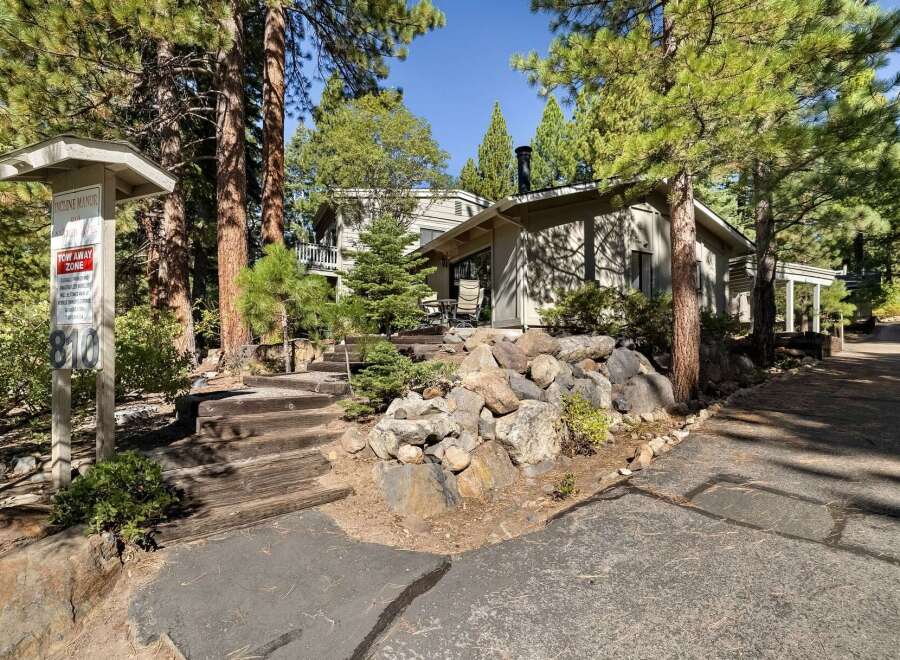 Nestled amidst towering pine trees, this charming property offers a serene mountain retreat.
