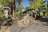 Nestled amidst towering pine trees, this charming property offers a serene mountain retreat.