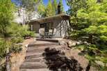 Enjoy outdoor living with this charming patio area, perfect for al fresco dining or morning coffee surrounded by mature trees.