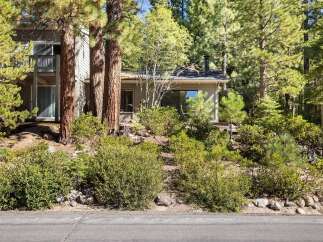 Nestled amongst tall pine trees, this charming property offers a serene retreat with its natural surroundings.